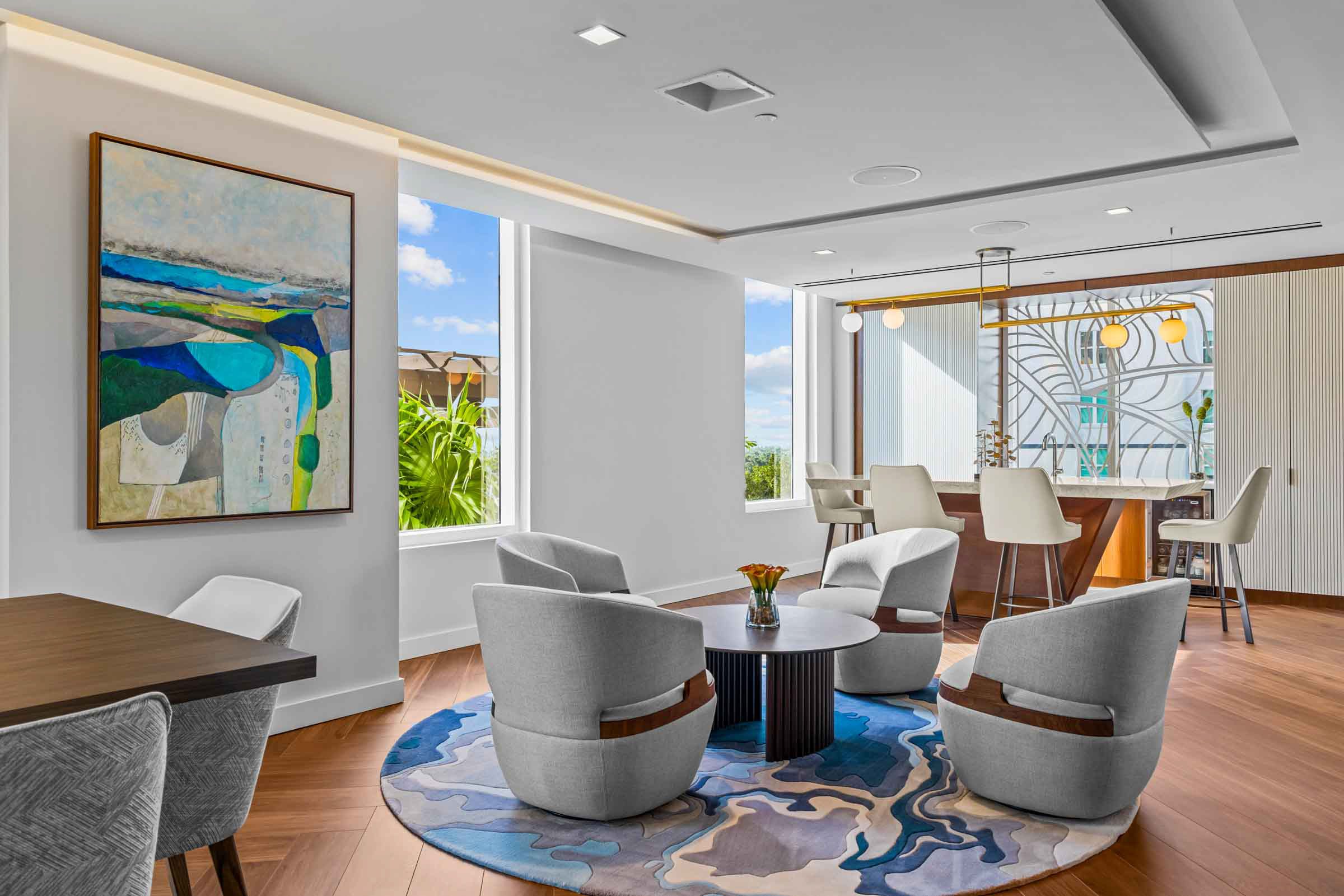Modern living room with stylish furniture and large windows.