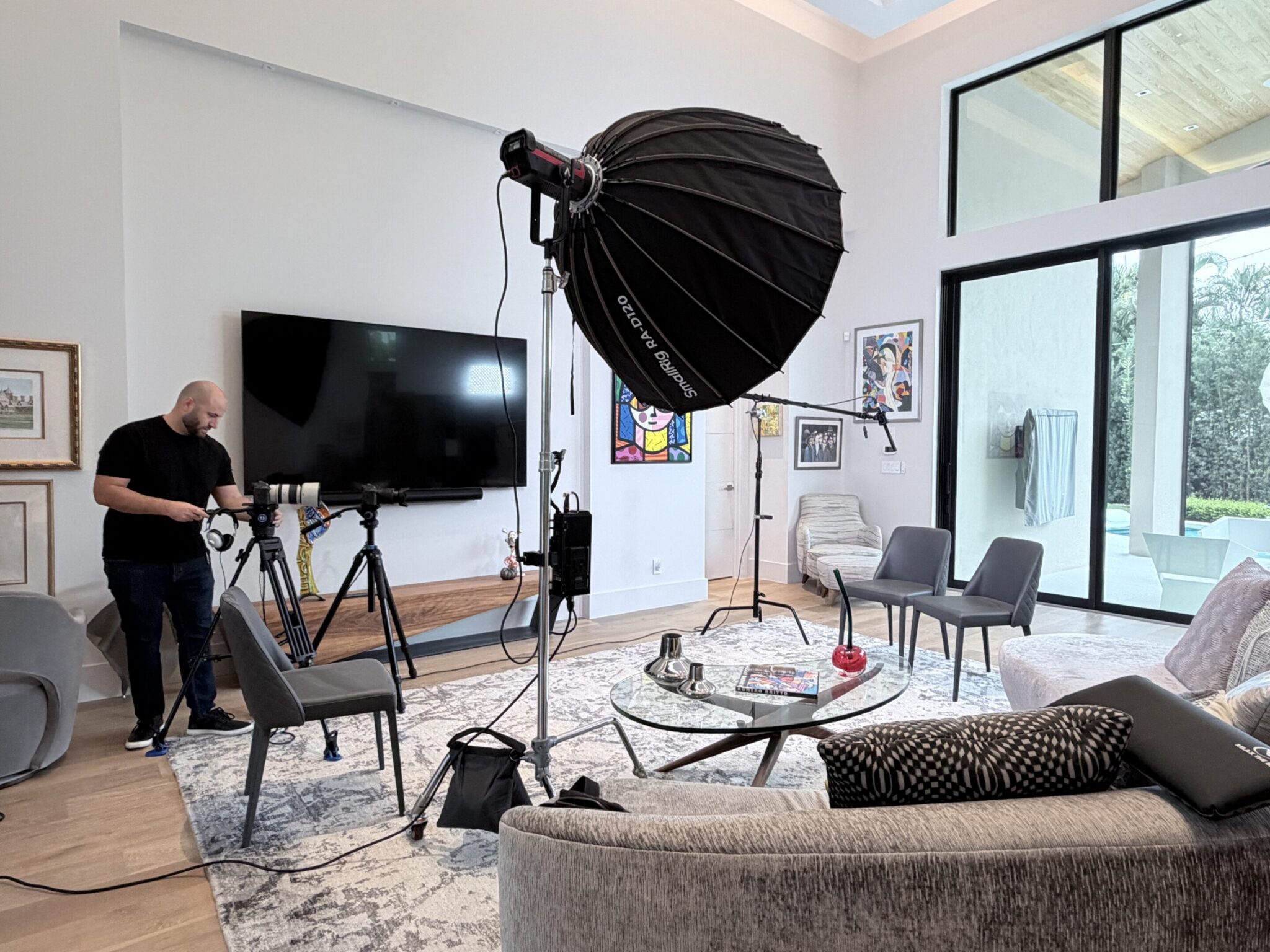 Professional video shoot setup in a modern living room.